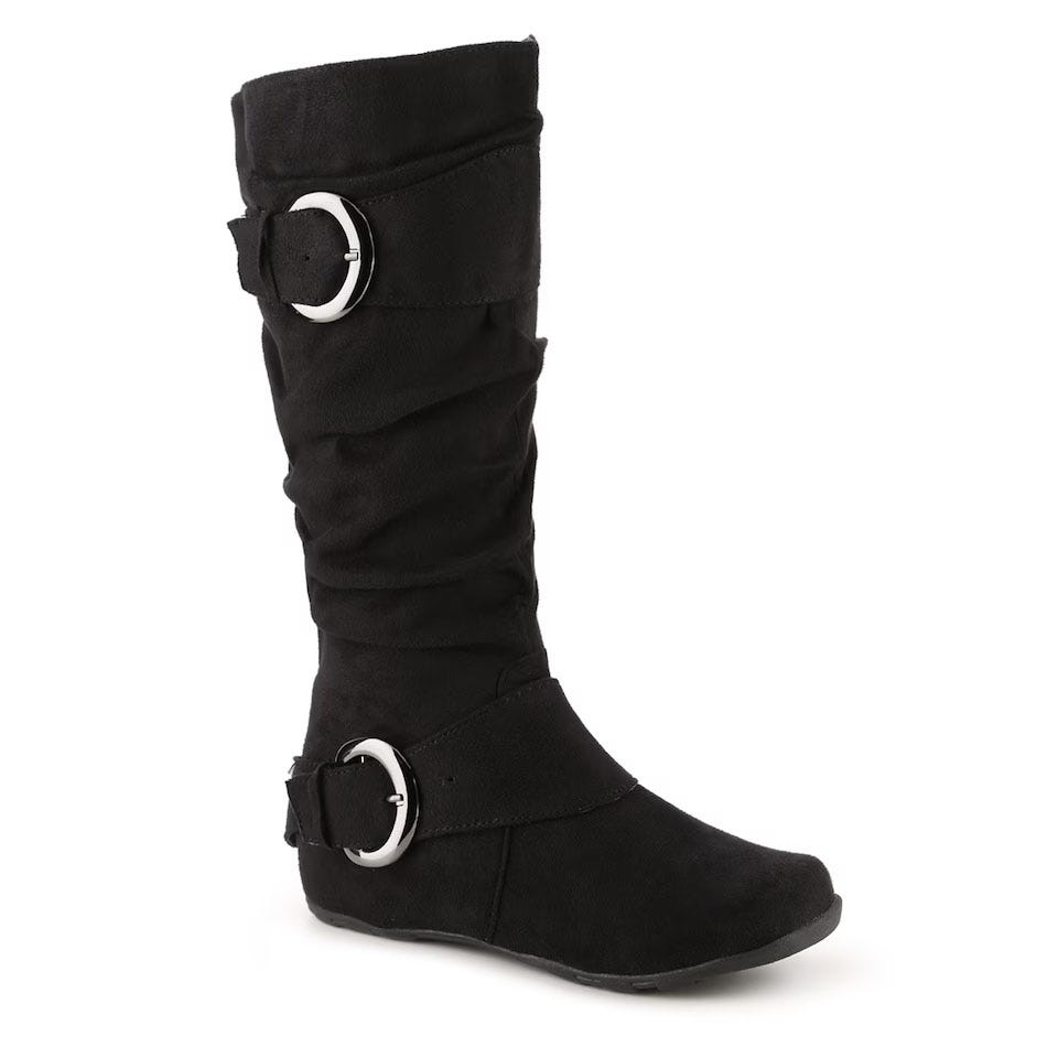 Black, mid-calf slouch boots with two decorative metal buckles and a flat heel, composed of a suede-like material.