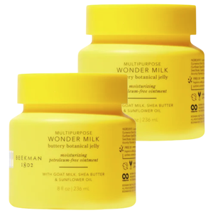 Two yellow jars labeled \“BEEKMAN 1802 Multipurpose Wonder Milk Buttery Botanical Jelly\“ contain 8 fl oz (236 ml) each. The moisturizing ointment is noted to be petroleum-free, featuring goat milk, shea butter, and sunflower oil.