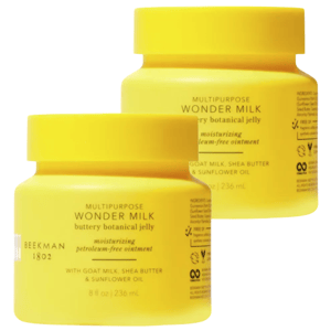 Two yellow jars labeled \“BEEKMAN 1802 Multipurpose Wonder Milk Buttery Botanical Jelly\“ contain 8 fl oz (236 ml) each. The moisturizing ointment is noted to be petroleum-free, featuring goat milk, shea butter, and sunflower oil.
