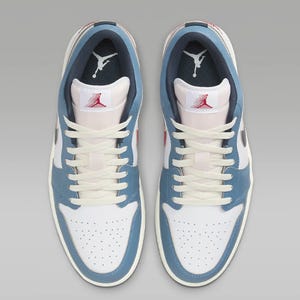 A pair of light blue and white high-top sneakers with the Jumpman logo on the tongues.