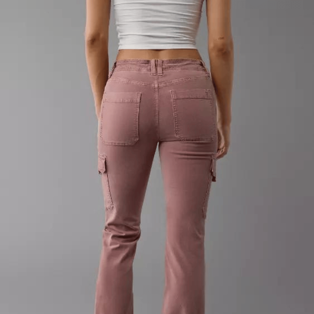 A person wearing mauve cargo-style pants and a cropped white top, viewed from the back.