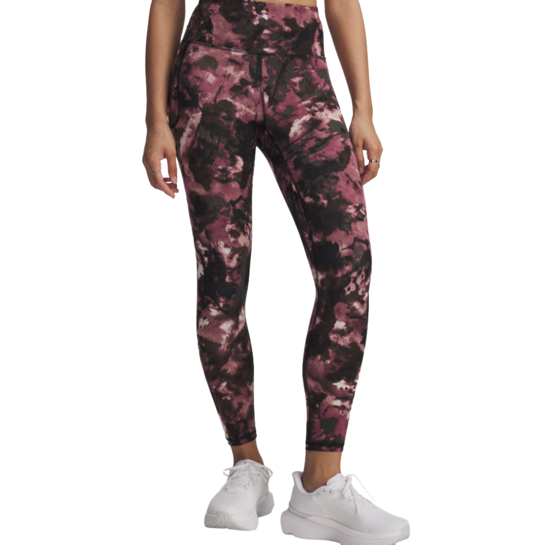 Leggings with a pink and black abstract pattern, worn with white sneakers.