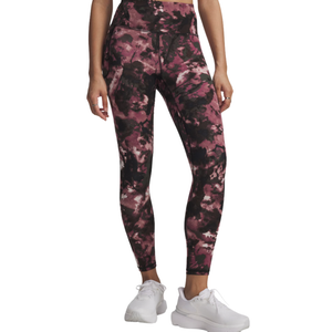 Leggings with a pink and black abstract pattern, worn with white sneakers.