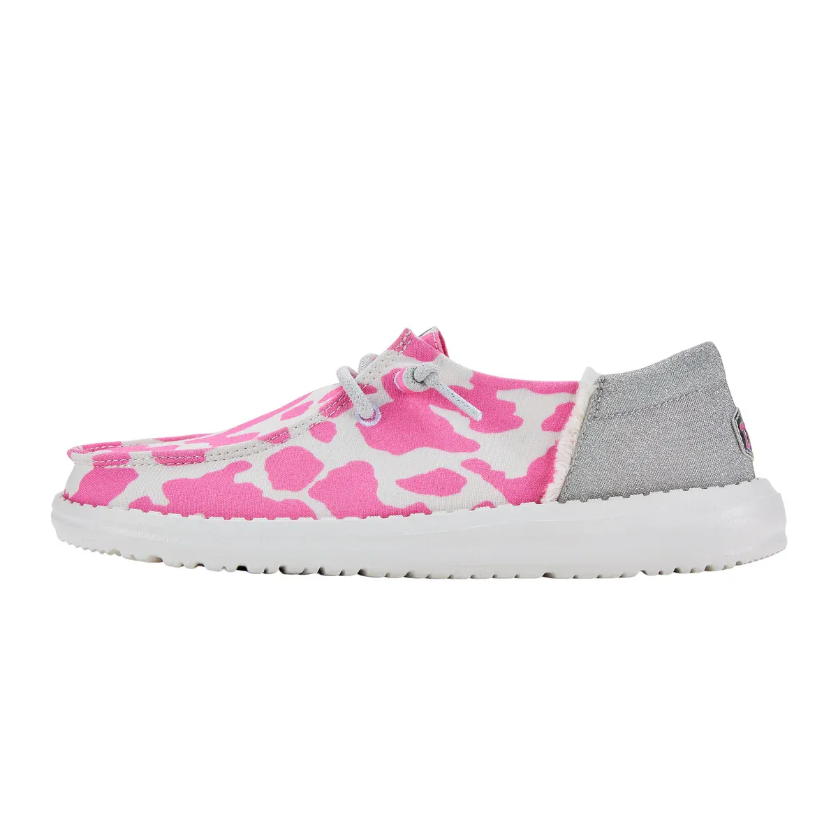 Casual slip-on shoes with a pink and white cow print pattern, gray heel panel, and a white sole.