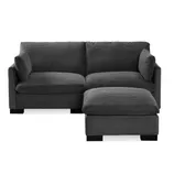 A dark gray sectional sofa with corduroy fabric, featuring a chaise lounge on the right side.