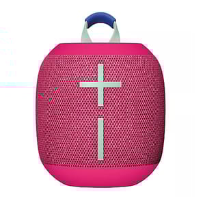 A pink Logitech Wonderboom 4 Bluetooth speaker with a cylindrical shape, featuring a large plus and minus sign on the front for volume control and a blue handle on top for portability.