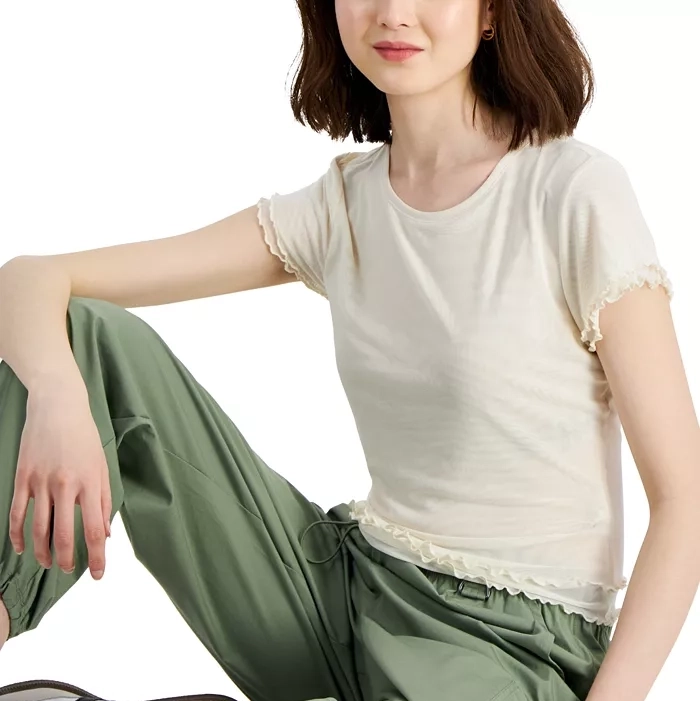 White T-shirt with ruffle sleeve details paired with green drawstring pants.
