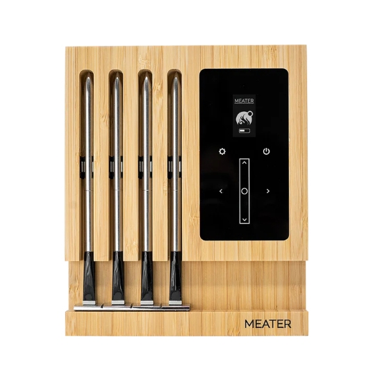 A Meater wireless meat thermometer set with four probes is shown on a bamboo charging block, featuring a digital display for cooking temperature monitoring.