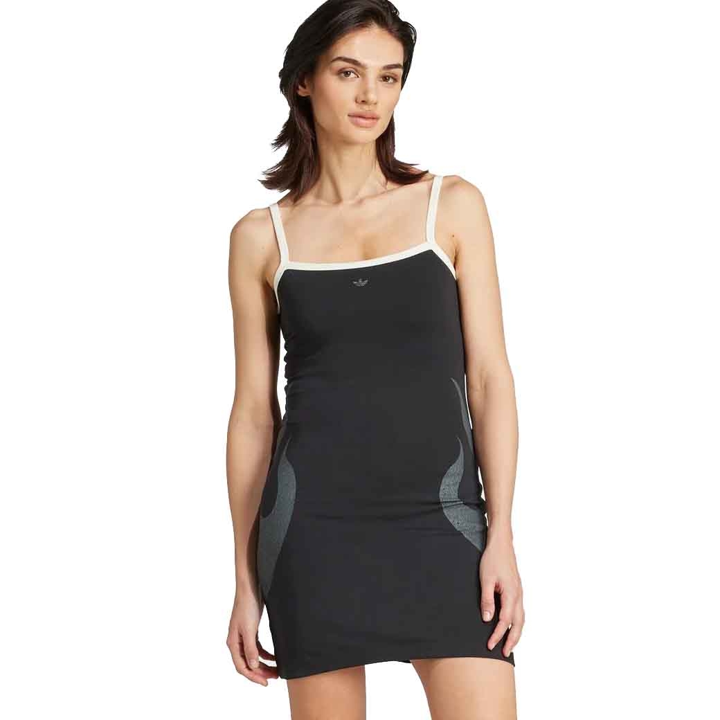 A woman wears a black sleeveless dress with white trim and subtle gray accents, featuring thin shoulder straps and a fitted silhouette.