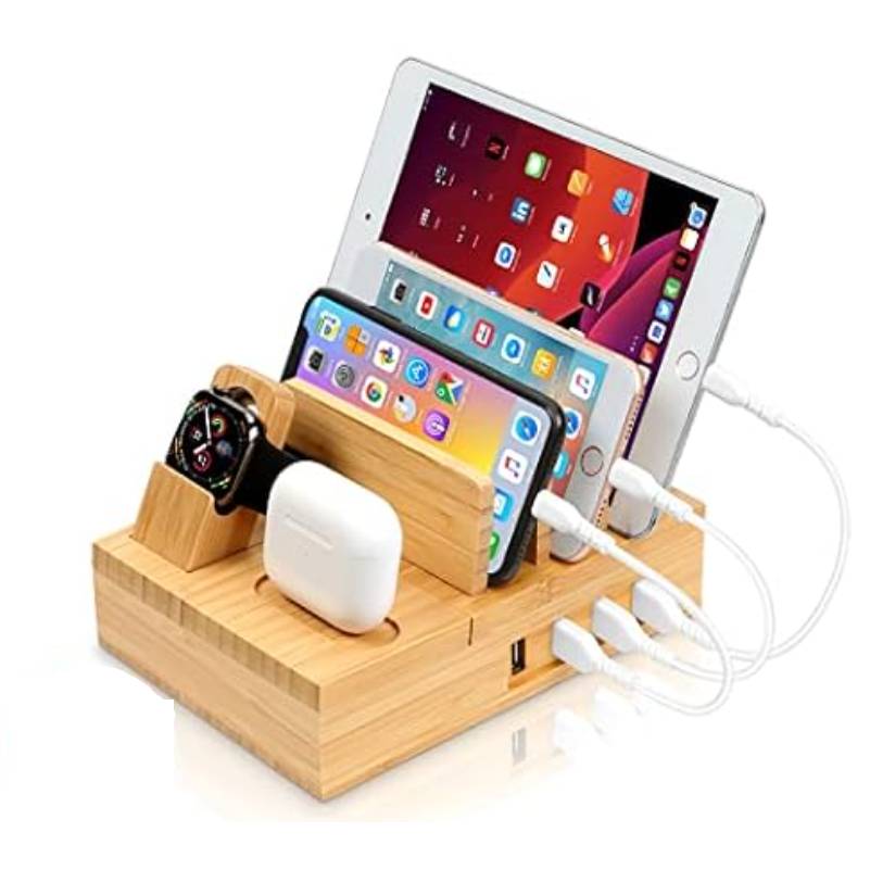 Bamboo charging station holding an iPad, two smartphones, a smartwatch, and wireless earbuds, with multiple charging cables connected.