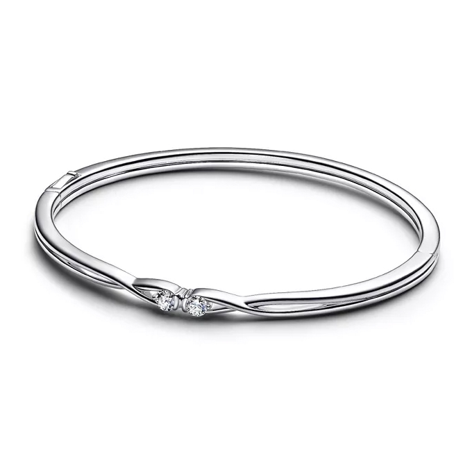 A sleek silver bangle bracelet featuring two small, round-cut diamonds set within a twist design for a minimalist yet elegant look.