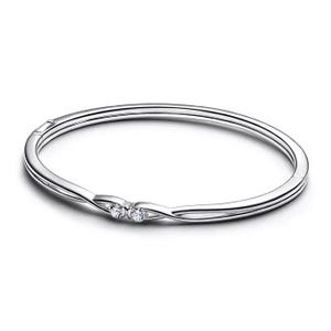 A sleek silver bangle bracelet featuring two small, round-cut diamonds set within a twist design for a minimalist yet elegant look.