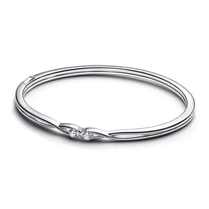 A sleek silver bangle bracelet featuring two small, round-cut diamonds set within a twist design for a minimalist yet elegant look.