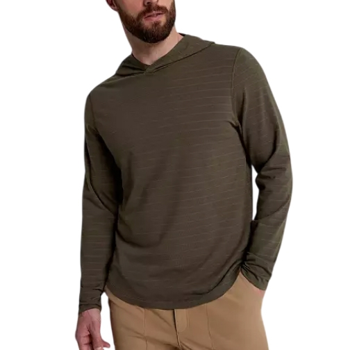 A man wears a VRST Men's Essential Hoodie, featuring a light olive color with fine horizontal stripes, long sleeves, and a comfortable hood, paired with beige pants.