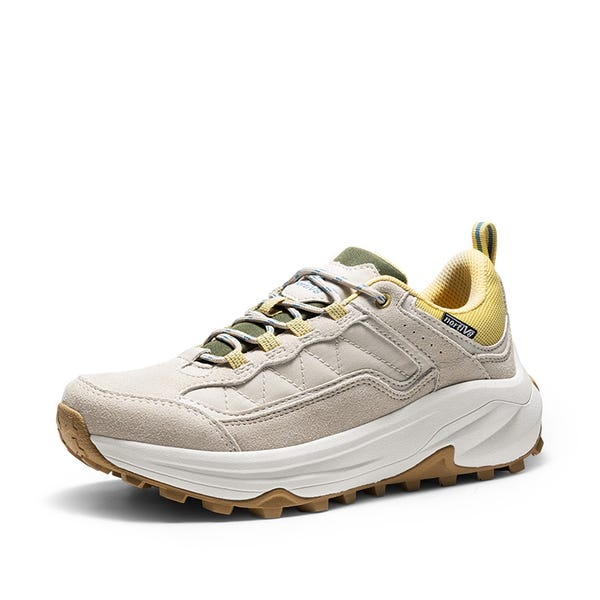 A beige and white trail shoe with yellow and green accents, featuring a chunky sole and durable laces for outdoor activities.