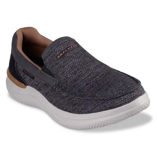 A Skechers slip-on shoe in dark gray with a textured pattern, featuring a white sole and tan interior accents.
