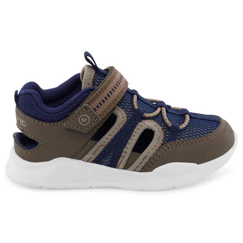 The Brinley Sneaker Sandals feature a sporty design with a brown and navy color scheme, a breathable mesh upper, adjustable hook-and-loop strap, and a white rubber outsole for comfort and support.