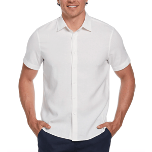 A man is wearing a short-sleeve, white button-up shirt with a collar, paired with dark trousers.