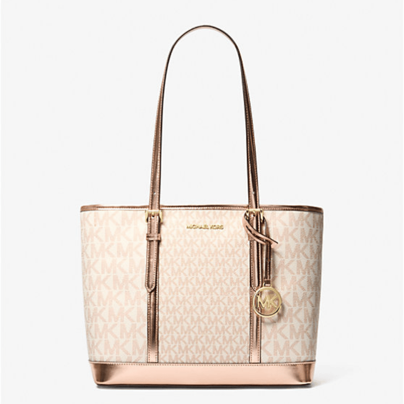 A beige tote bag with a monogram pattern, brown trim, and a hanging circular logo charm.