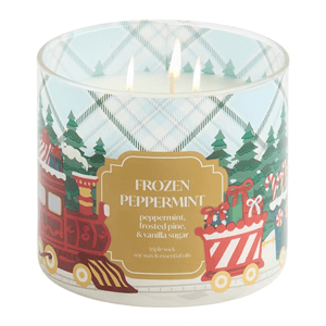 A triple-wick candle labeled \“Frozen Peppermint,\“ featuring scents of peppermint, frosted pine, and vanilla sugar. The design includes festive trains and Christmas trees.