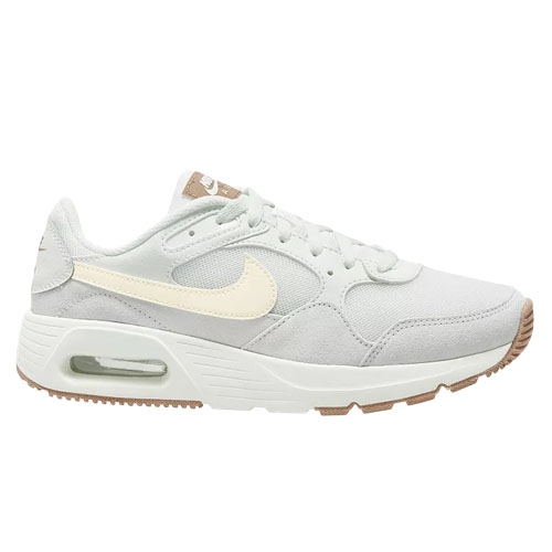 A light grey Nike sneaker featuring a cream-colored swoosh, a visible air unit in the heel, and a rubber sole with beige accents.