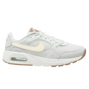 A light grey Nike sneaker featuring a cream-colored swoosh, a visible air unit in the heel, and a rubber sole with beige accents.