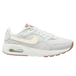 A light grey Nike sneaker featuring a cream-colored swoosh, a visible air unit in the heel, and a rubber sole with beige accents.