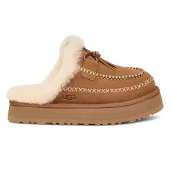 Tan slip-on UGG slipper with a fluffy interior lining and detailed stitching, featuring a platform sole.