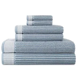 A set of blue and white patterned towels stacked in descending size order, including bath towels, hand towels, and washcloths.