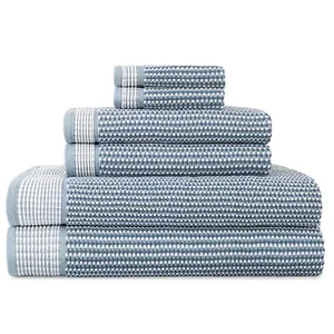 A set of blue and white patterned towels stacked in descending size order, including bath towels, hand towels, and washcloths.