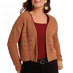 A woman wears a brown knitted cardigan over a maroon top, paired with black jeans and a gold buckle belt, accessorized with teardrop-shaped earrings.