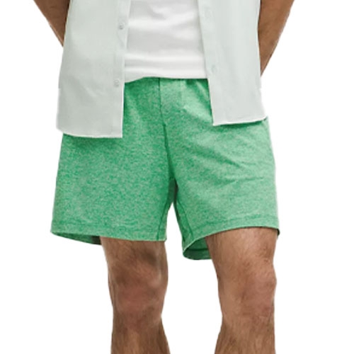 Light green men's shorts paired with a white shirt, worn by a model.
