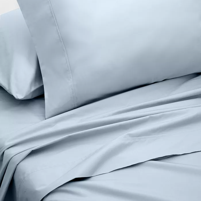 Light blue bed sheet set with a plain design, including a pillowcase and a flat sheet.