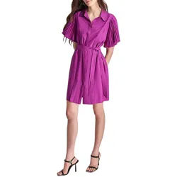 A woman is wearing a violet, pleated short-sleeve dress with a collar and a matching belt. She pairs it with black high-heeled sandals.