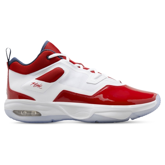 A white, red, and blue basketball shoe with patent leather detailing and visible air cushioning.