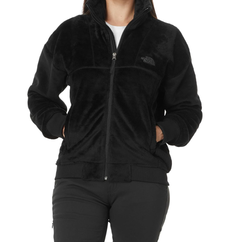 The North Face Luxe Osito Jacket is a black, plush, full-zip jacket with a high collar and two front pockets, designed for warmth and comfort.