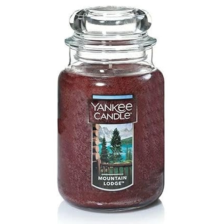 A Yankee Candle branded large jar candle with a \“Mountain Lodge\“ scent label.