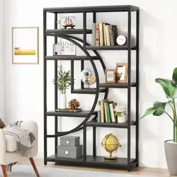 A stylish black shelving unit with geometric design displays books, decorative items, and a small globe. It is placed in a modern living room alongside a beige couch and a potted plant.