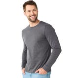 A man models a long-sleeve gray shirt paired with light blue jeans.