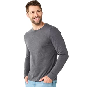 A man models a long-sleeve gray shirt paired with light blue jeans.
