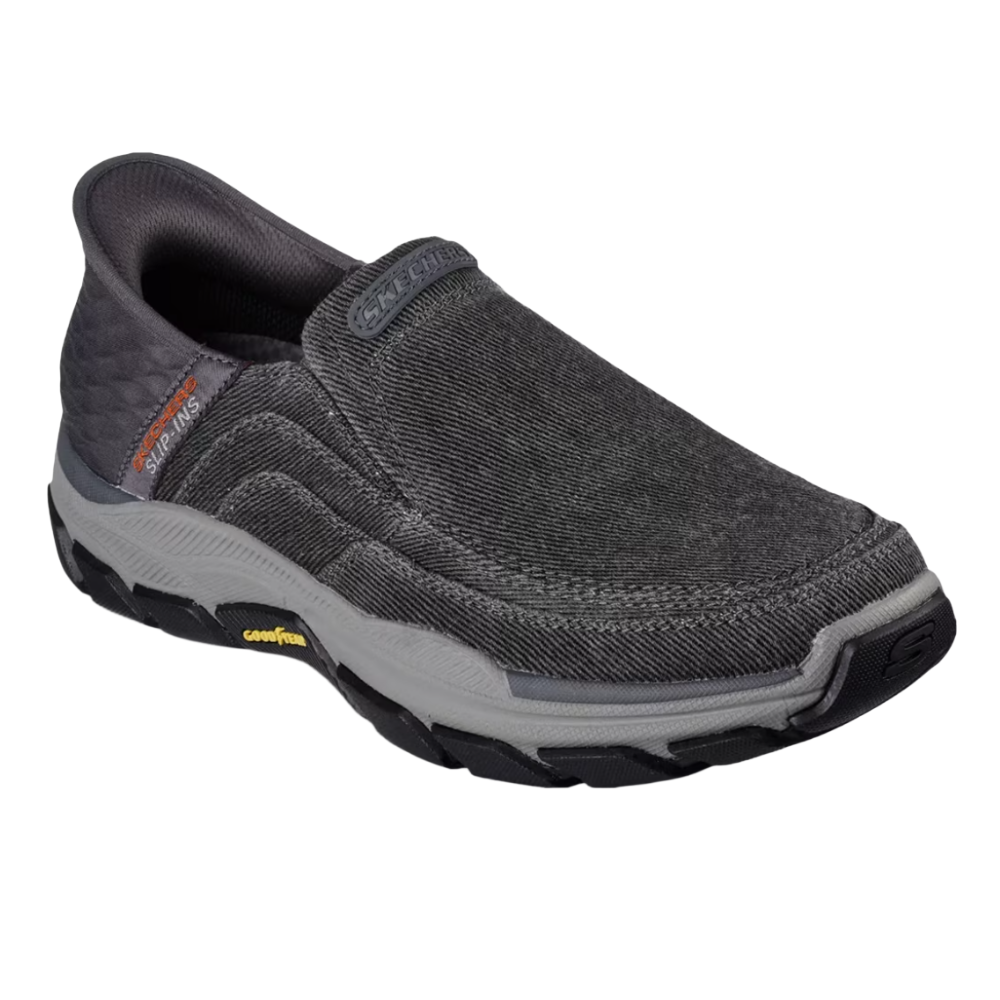 Slip-on shoe with a dark gray, textured fabric upper, cushioned sole, and contrasting black and gray outsole. Features \“Slip-Ins\“ branding on the side and \“Goodyear\“ on the sole.