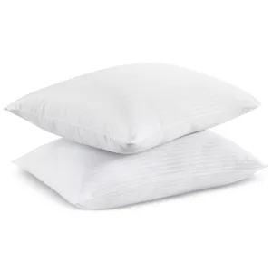 Two white pillows with a subtle striped pattern, stacked on top of each other.
