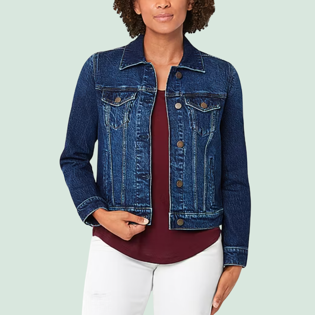 Denim jacket with button closure, pointed collar, and chest pockets, paired with a maroon top and white pants.