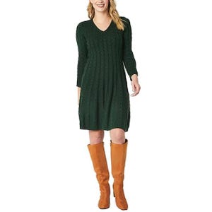 A forest green, knee-length sweater dress with a V-neck and long sleeves features a cable knit pattern. It's paired with tall, tan boots.