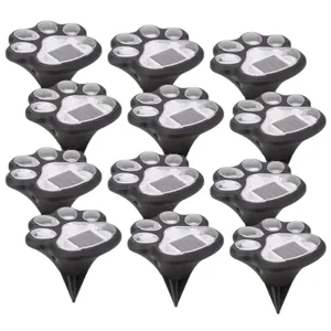 Set of solar-powered outdoor lights designed to look like paw prints, each featuring a ground stake for easy installation.