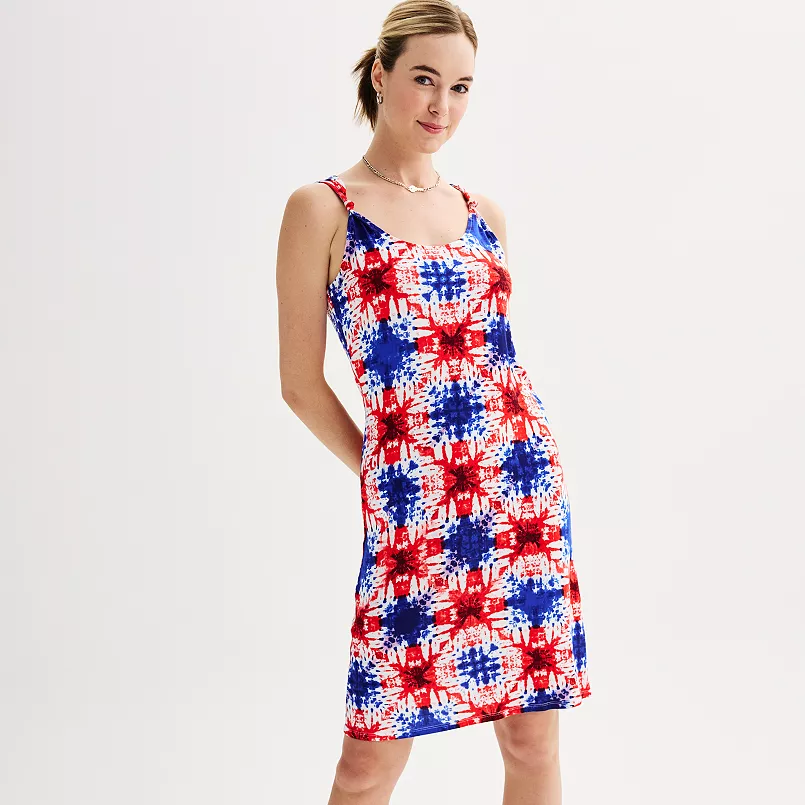 A woman wearing a sleeveless red, white, and blue tie-dye dress.