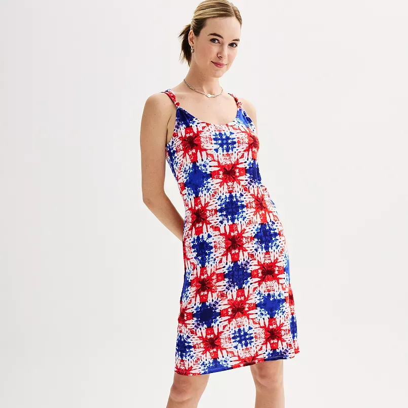 A woman wearing a sleeveless red, white, and blue tie-dye dress.