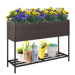 Rattan-style raised planter with purple and yellow flowers, featuring metal legs and a lower shelf. Includes gardening tools and supplies like a watering can and buckets on the shelf.