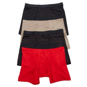 Hanes Ultimate 4pk Comfort Sport Briefs feature a pack of four briefs in black, beige, and red colors with a stretchy waistband. They offer a smooth fit, suitable for active wear.