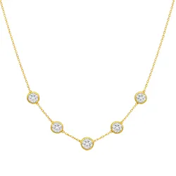 A gold chain necklace featuring five evenly spaced, bezel-set round clear gemstones.